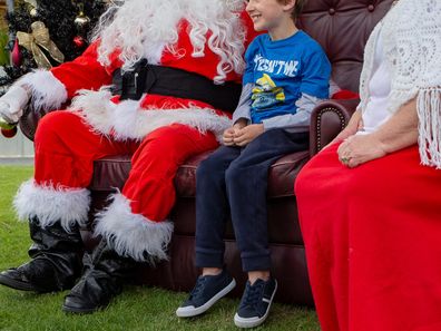 Santa and Mrs Claus meet child