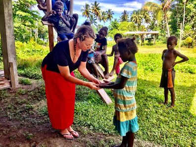 Dr Lucia Romani working with children in the Pacific.