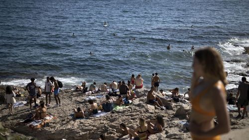In this, July 25, 2020, file photo, people enjoy the sun at the Malmousque Beach in Marseille, in southern France. 