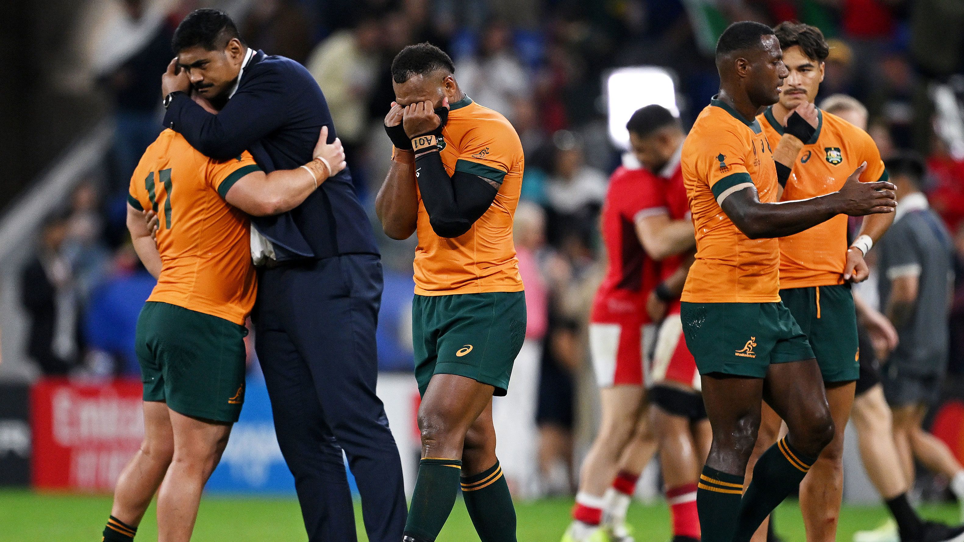 Injured Wallabies captain Will Skelton consoles Blake Schoupp as Samu Kerevi looks dejected at full-time following the Rugby World Cup match against Wales. 