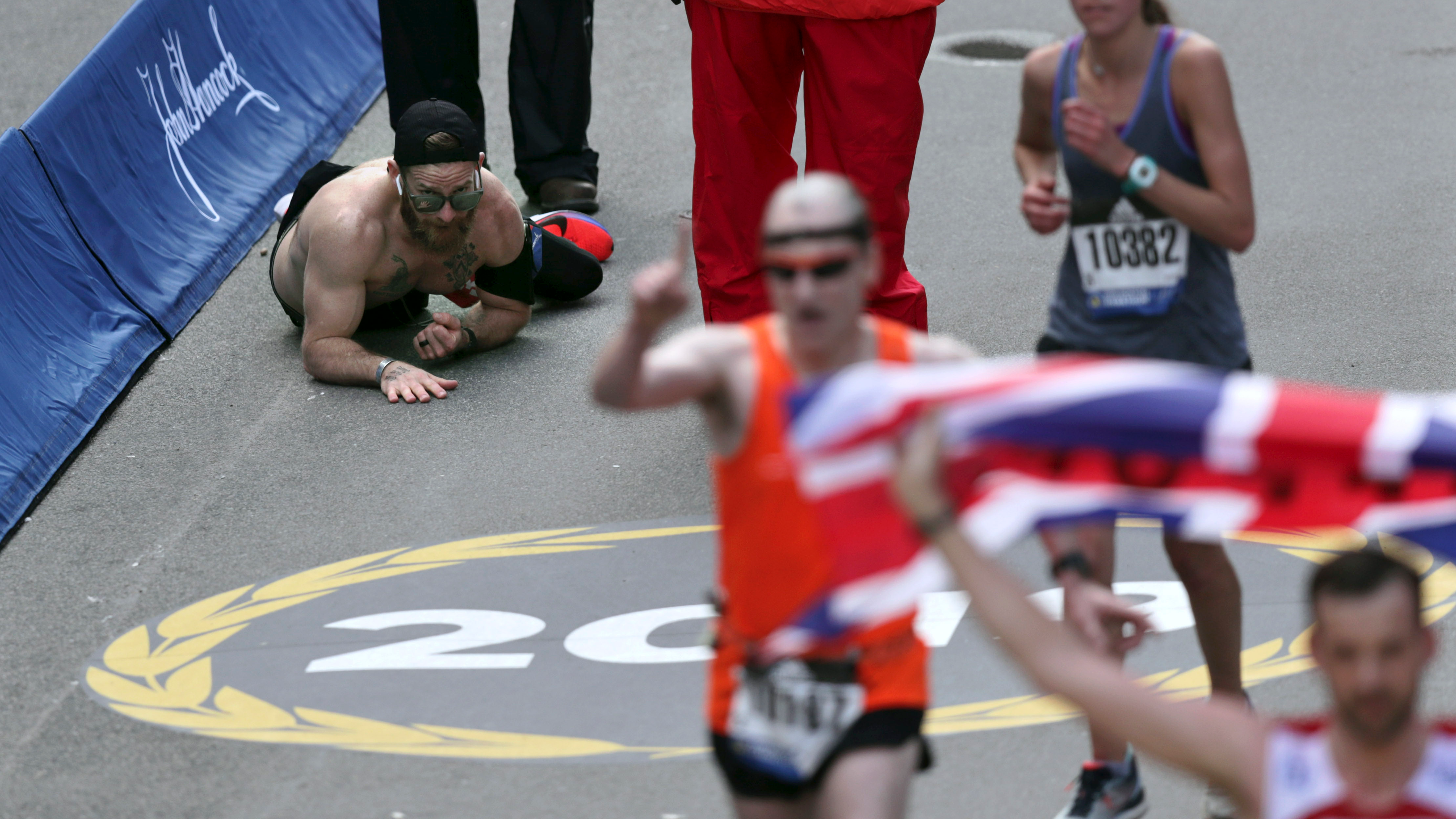 US marine running Boston Marathon for fallen comrades crawls to finish line