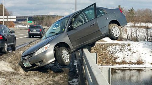 Lucky teen cheats death after crash leaves car perched on bridge