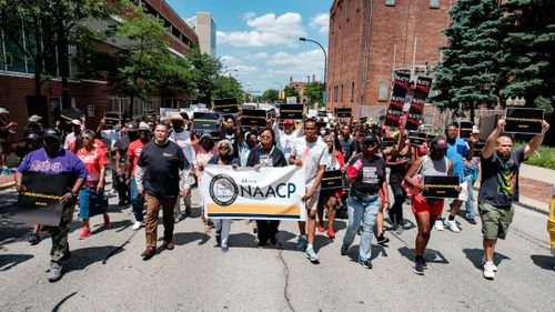 People walk in an NAACP-led march and rally for Jayland Walker