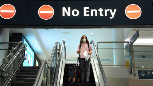 A woman arrives at the domestic terminal at Sydney airport off a Jetstar flight from Melbourne.