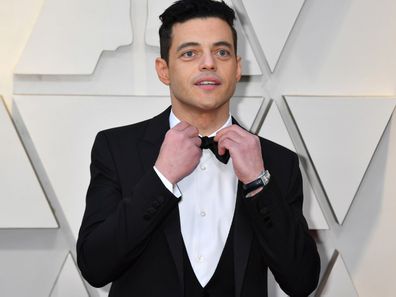 Rami Malek on the 2019 Oscars red carpet fixing his bow-tie