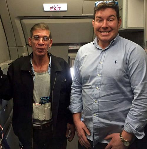 English passenger Ben Innes posing for a photo with the hijacker, who can be seen wearing a fake suicide belt.