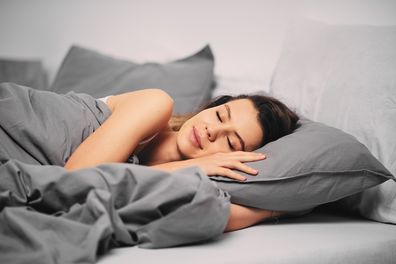 Girl lying down on the bed and  sleeping in the morning