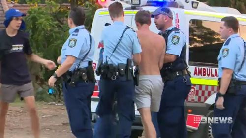 Police apprehend a young offender. (9NEWS)