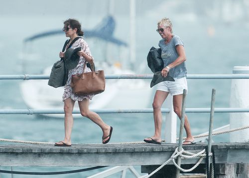 Princess Mary is caught in the rain as she disembarks and strolls along the jetty. Picture: Matrix News