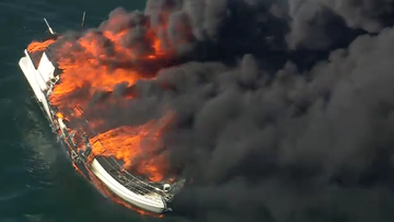 A boat is on fire in Port Phillip﻿, south of Melbourne&#x27;s city centre, sending plumes of black smoke into the sky.