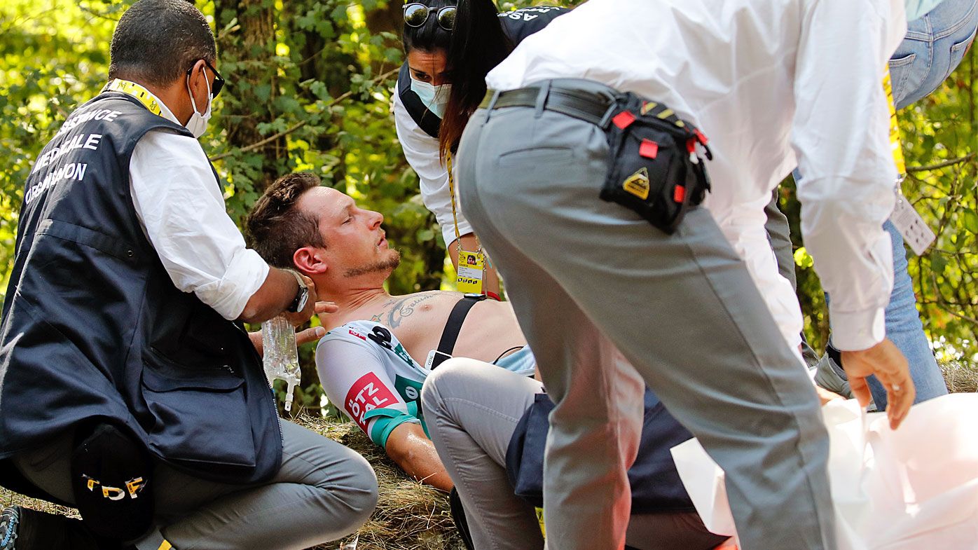 Lukas Postlberger of Austria is treated by medics during the stage 19 