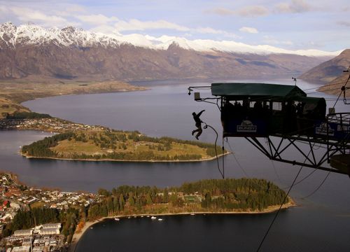 A person flings them self over the edge of an AJ Hackett Bungy jump over Queenstown, in New Zealand's South Island.