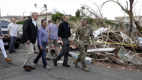 President Donald Trump takes a walking tour to survey hurricane damage. (AAP)