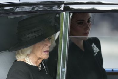 Camilla, the Queen Consort, left, and Kate, Princess of Wales sit in car during the procession of the Gun Carriage which will carry the coffin of Queen Elizabeth II from Buckingham Palace to Westminster Hall in London, Wednesday, Sept. 14, 2022. The Queen will lie in state in Westminster Hall for four full days before her funeral on Monday Sept. 19. (AP Photo/Frank Augstein, Pool)
