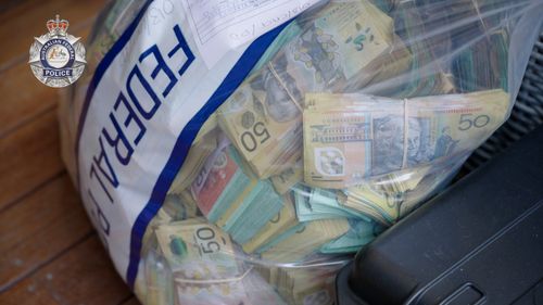 Police seized more than $1.5 million worth of cash hidden inside one Canberra home.