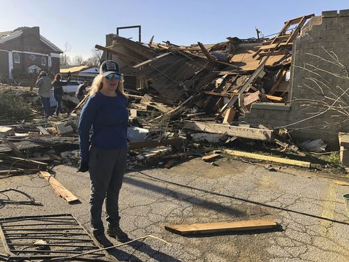 Heidi Jenkins, owner of Boulevard Salon, speaks with a reporter in front of her destroyed business in Wynne, Ark., on Saturday, April 1, 2023. 