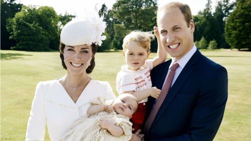 Catherine, The Duchess of Cambridge holding her daughter Princess Charlotte next to her husband Prince William, The Duke of Cambridge, carrying their son Prince George. (Mario Testino)