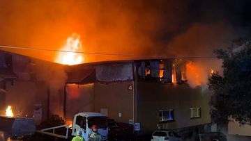 Fire crews are fighting a &quot;significant&quot; and &quot;fierce&quot; north Sydney car workshop fire, which has damaged several cars and sent &quot;thick, acrid smoke&quot; spewing into the sky.