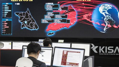 Employees watch an electronic board to monitor possible ransomware cyber-attacks at the Korea Internet and Security Agency in Seoul. 