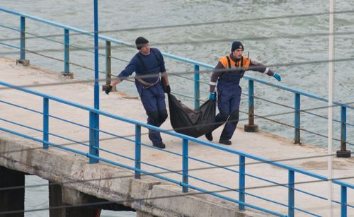 Rescuers carry fragments and remains, found at the site of the Tu-154 plane crash near Sochi, Russia, 25 December 2016. According to media reports, a Tupolev-154 Russian airplane carrying at least 92 people disappeared from radar and crashed into the Black Sea after taking off from an airport in Sochi on 25 December. The plane which was flying to Latakia, Syria, was reportedly carrying 65 members of the Alexandrov Ensemble, eight crew members, nine Russian journalists as well as Russian civil activist, Doctor Yelizaveta Glinka (Doctor Liza). 