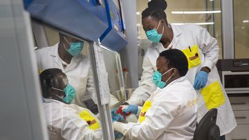 Melva Mlambo, right, and Puseletso Lesofi, both medical scientists prepare to sequence COVID-19 omicron samples at the Ndlovu Research Center in Elandsdoorn, South Africa Wednesday Dec. 8, 2021.  