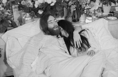 (Original Caption) Yoko and John...Beatle John Lennon and Yoko Ono, his bride of three months at the time this photo was made in Montreal in June 1969, pose in bed. His first solo album at the time featured songs telling of his love for Yoko. They held, in bed, press conferences in several cities with the theme, "make love, not war." Lennon was shot to death December 8, 1980. In a statement December 9th, Miss Ono said, "There is no funeral for John. Later in the week we will set the time for sil