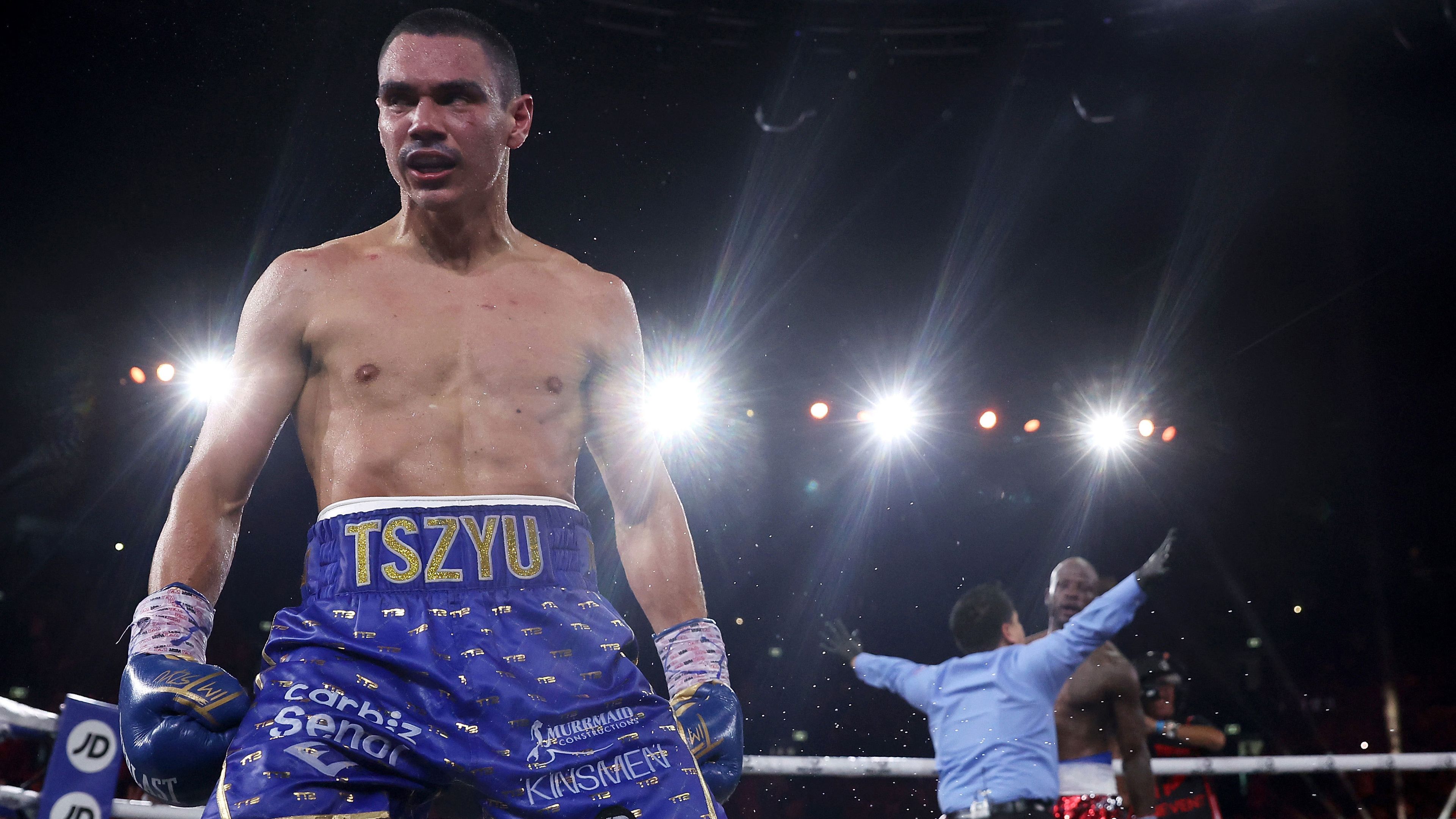 Tim Tszyu celebrates victory in his WBO super-welterweight world title fight against Tony Harrison as the referee signals for the stoppage.