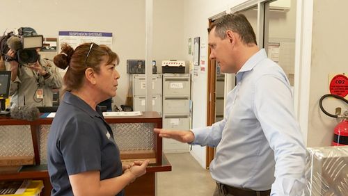 The Chief Minister of the Northern Territory has been ambushed by an angry businesswoman as he was promoting a government-funded economic stimulus.