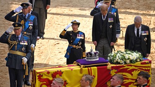 Prince Harry and Prince Andrew, both on the outer, did not wear military uniform, and there also not allowed to salute a war memorial.