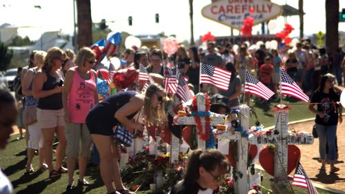 People visit a Las Vegas memorial dedicated to the 58 victims who were shot and killed by Stephen Paddock.