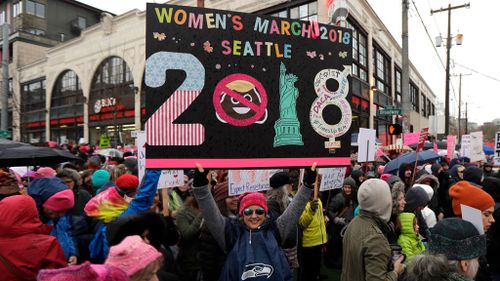 A woman holds as sign as she takes part in a Women's March in Seattle. (AP)