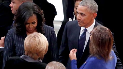 Michelle and Barack Obama arrive for the funeral of George HW Bush.