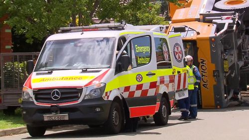 Paramedics look over the crane operator in Clemton Park.