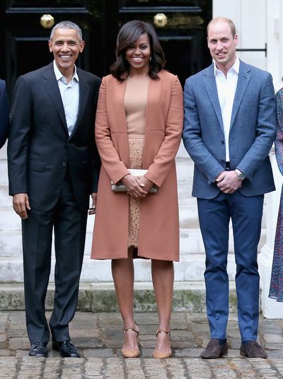 Michelle Obama in a Narcisco Rodriguez coat at Kensington Palace with the Duke of Cambridge and Barack Obama