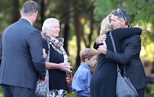 Aaron Cockman was comforted by loved ones. (AAP)
