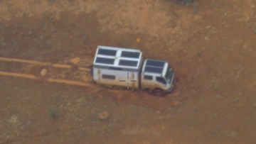 The family was trapped when their vehicle was bogged in the wet outback.