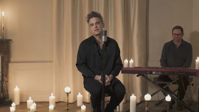 Robbie Williams performs during Shane Warne's memorial