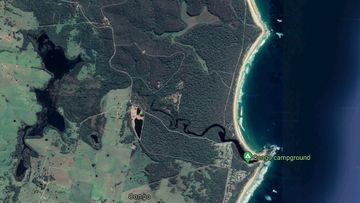 A surfer tried to save a 50-year-old woman caught in a rip at Congo Beach, south of Moruya, but she died after being dragged back to shore.
