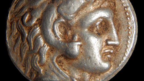 The figure of Alexander the Great appears on one side of some of the coins. (Shmuel Magal/Israel Antiquities Authority)