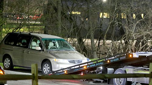 The Honda minivan is removed from the parking lot near the Seven Hills School campus in Cincinnati.(AP).