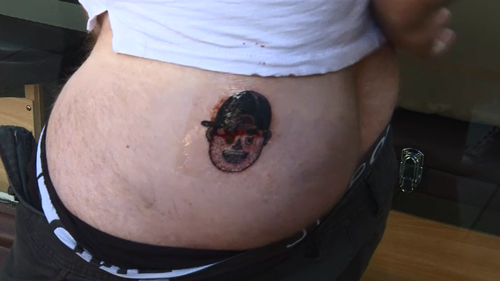 Tom Scullie is now sporting a cheeky tattoo of his brother-in-law Eddie Betts face on his bum after losing a bet against the Adelaide Crows great.