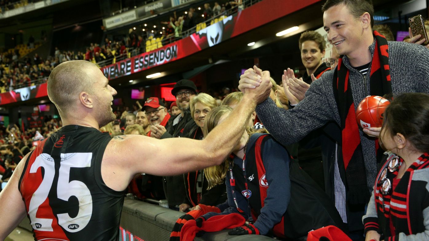 Jake Stringer of the Bombers celebrate with fans after the Round 4 AFL match between the Essendon Bombers and the Port Adelaide Power at Etihad Stadium in Melbourne, Sunday, April 15, 2018