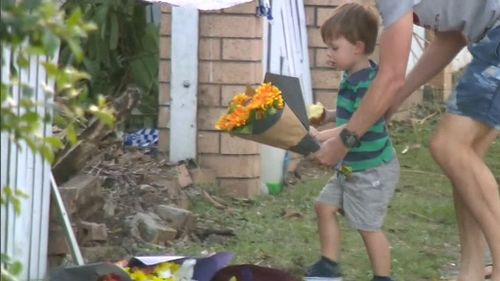 Members of the Beenleigh community were also seen laying flowers at the crash site.