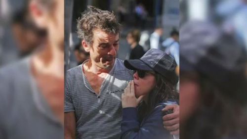 Harriette Denny, comforted by her partner, at the memorial in Martin Place. (9NEWS)