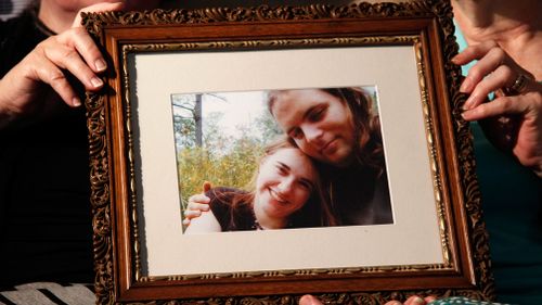 Linda Boyle and Lyn Coleman hold a photo of their married children, Canadian citizen Joshua Boyle and American citizen Caitlan Coleman. (AAP)