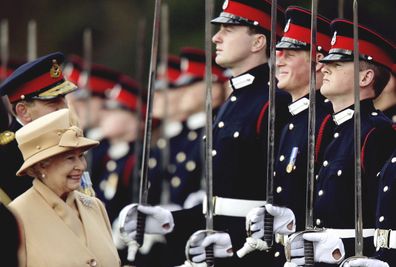FILE - In this Wednesday, April 12, 2006 file photo, Britain's Prince Harry, second from right, grins and his grandmother Queen Elizabeth II smiles, as she inspects the Sovereign's Parade at the Royal Military Academy in Sandhurst, England. Princess Dianas little boy, the devil-may-care red-haired prince with the charming smile  is about to become a father. 