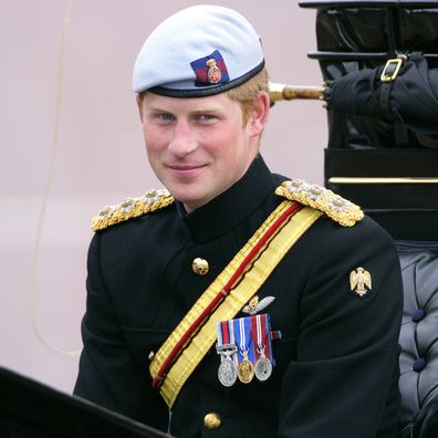 Prince Harry travels in a horse drawn carriage down The Mall during the annual Trooping the Colour Ceremony at Buckingham Palace on June 16, 2012.