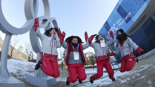 Volunteer workers celebrating in Pyeongchang ahead of the Winter Olympics in February. (AAP)