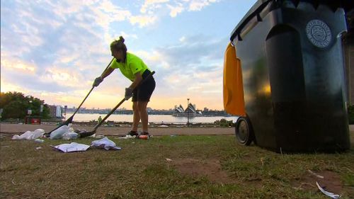 A council worker collects rubbish.