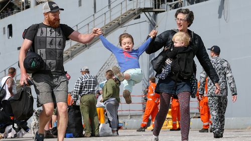 Evacuees from Mallacoota arrive on the navy ship HMAS Choules at the port of Hastings, Victoria, Saturday, January 4, 2020. 